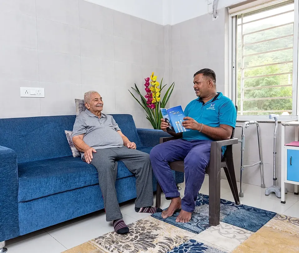 Elderly person reading a book peacefully at Golden Sky care center